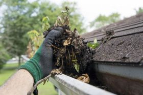 Cleaning gutters. How Gutter Problems Can Lead To A Damaged Roof