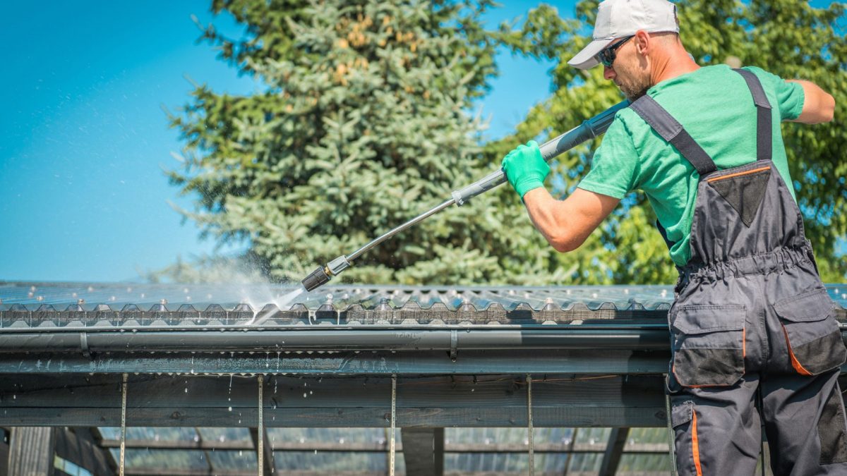 A professional from a gutter cleaning business performs work on residential gutters.